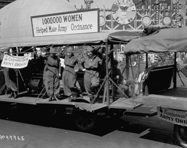 Women who worked in factories helping to make Army ordnance are featured in parade celebrating Armistice Day